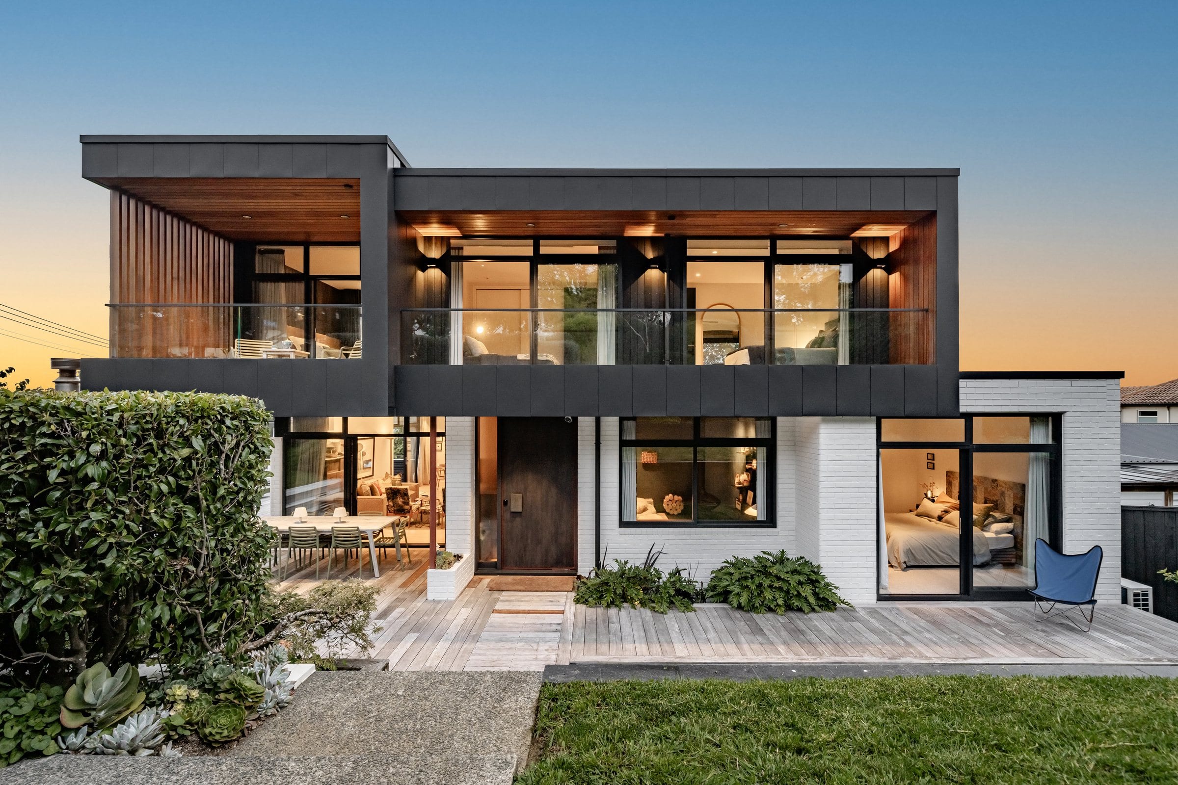 97 Lucerne Road at dusk, a two-storey contemporary home with a timber screen