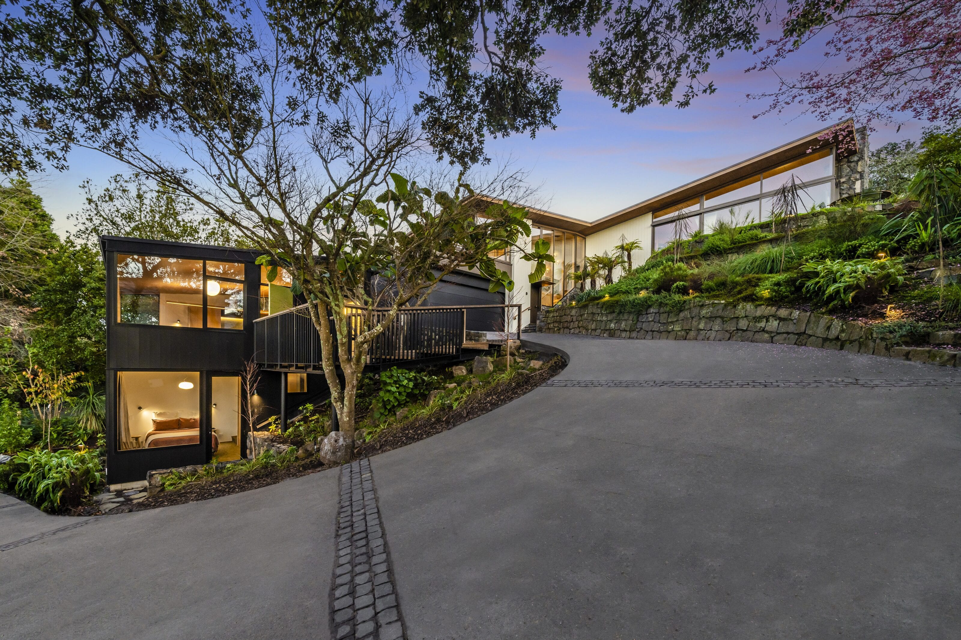 33 Market Road at dusk, the dark cedar pavilion above its drive