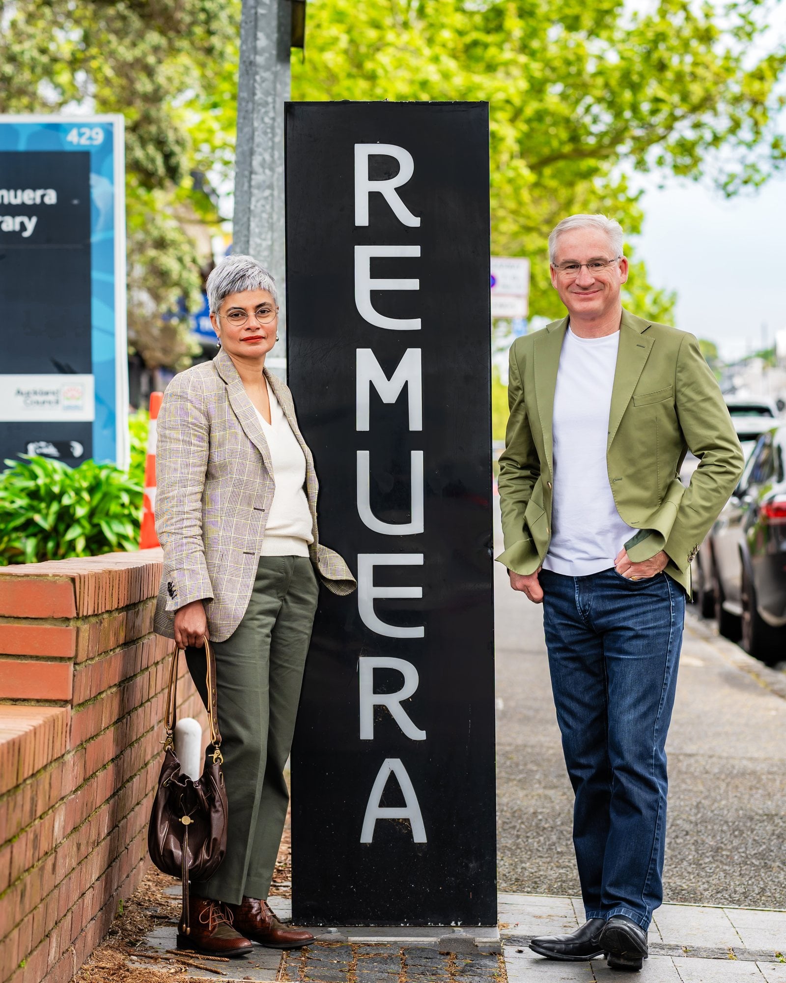 Steve and Nila Koerber standing either side of the REMUERA sign